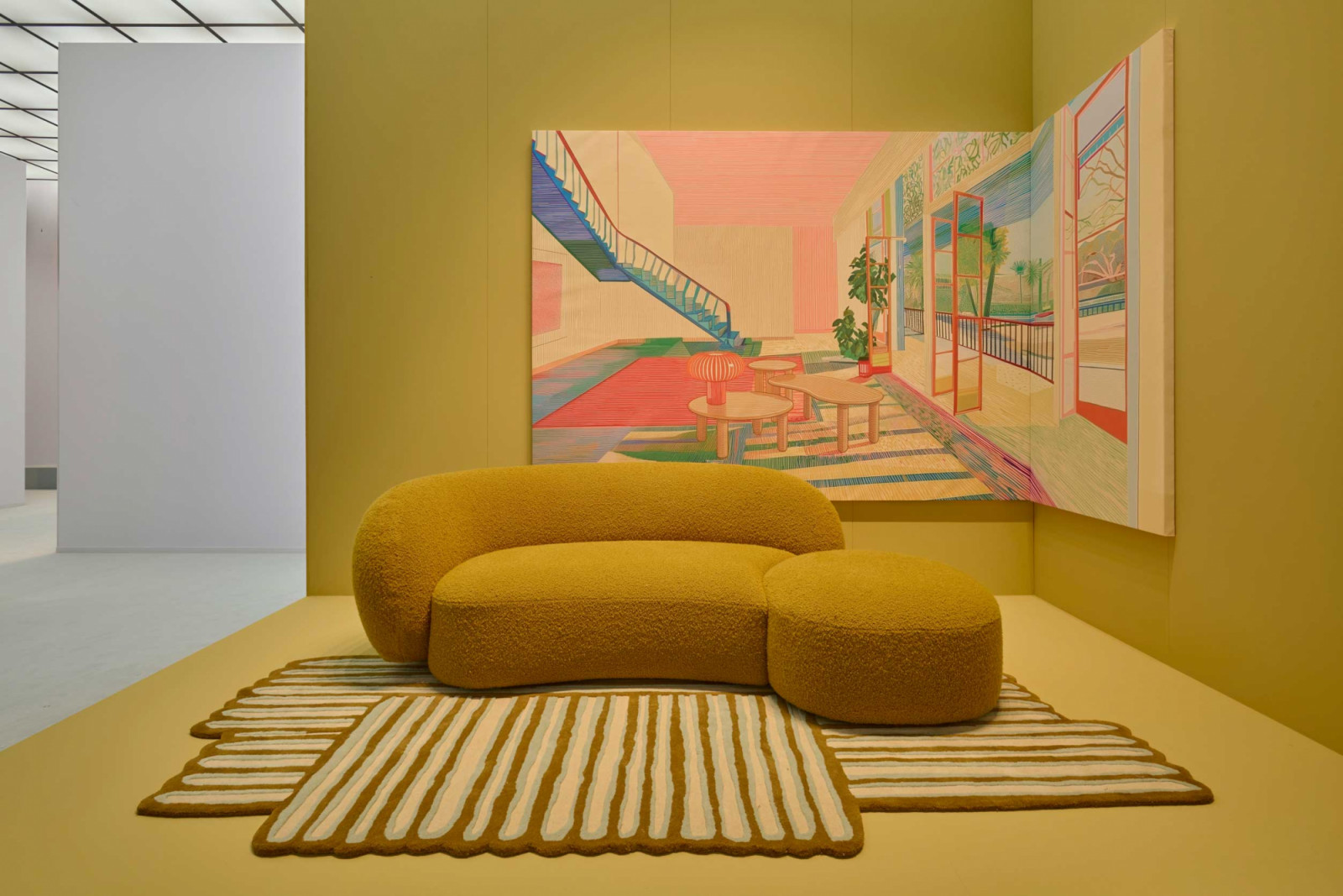 Both the Kartell Aaland 2.0 sofa and Pincel rug by Patricia Urquiola sport an ochre colour scheme