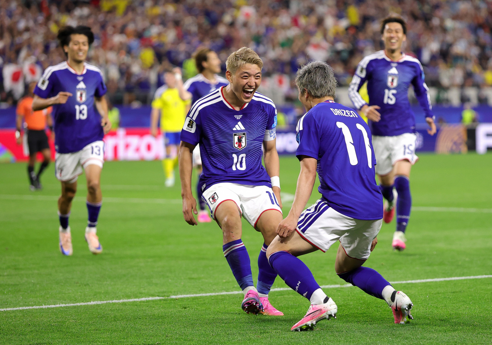 ARLINGTON, TEXAS - JUNE 25: Daizen Maeda #11 of Japan celebrates with teammate Ritsu Doan #10 after scoring his team's first goal during the FIFA World Cup 2026 Group F match between Japan and Sweden at Dallas Stadium on June 25, 2026 in Arlington, Texas. (Photo by Alex Slitz/Getty Images)