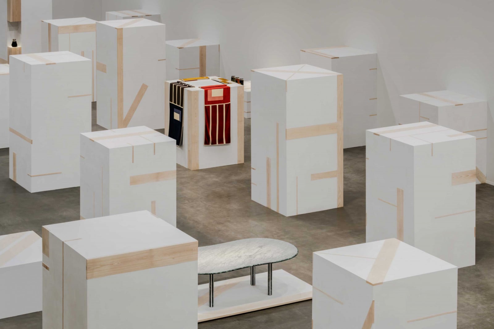 The 2026 Hermès Collections for the Home peek out between some 30 plaster volumes in the former jai alai court