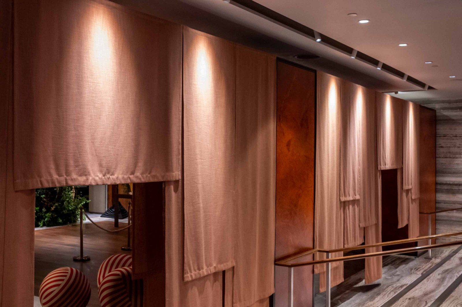 Noren-style curtain installation by Coesa marks the threshold of the cocktail reception to the living room installation area