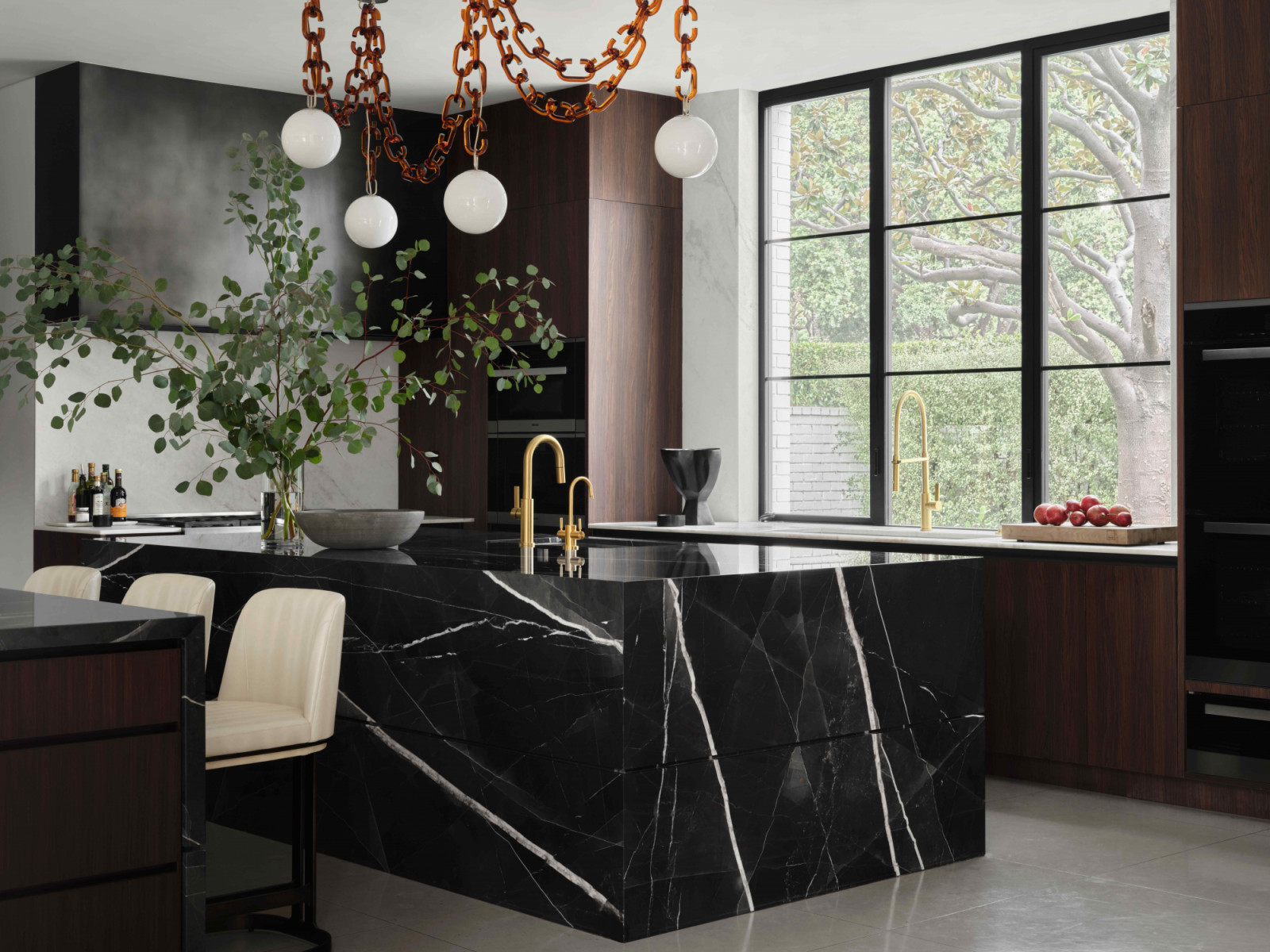 The sleek kitchen area next to the dining spaces
