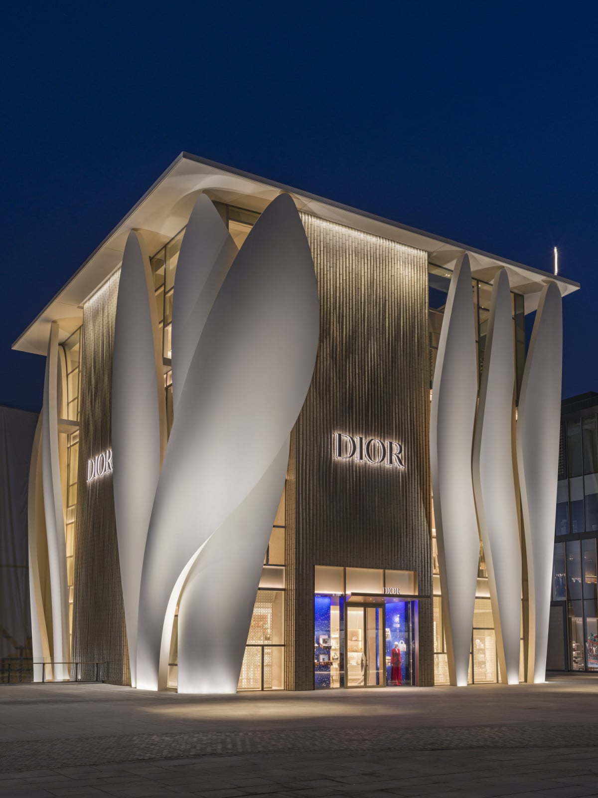 At night, the building’s seven shells read as a single gesture, lit from within to reveal their layered structure (Photo: Kristen Pelou)