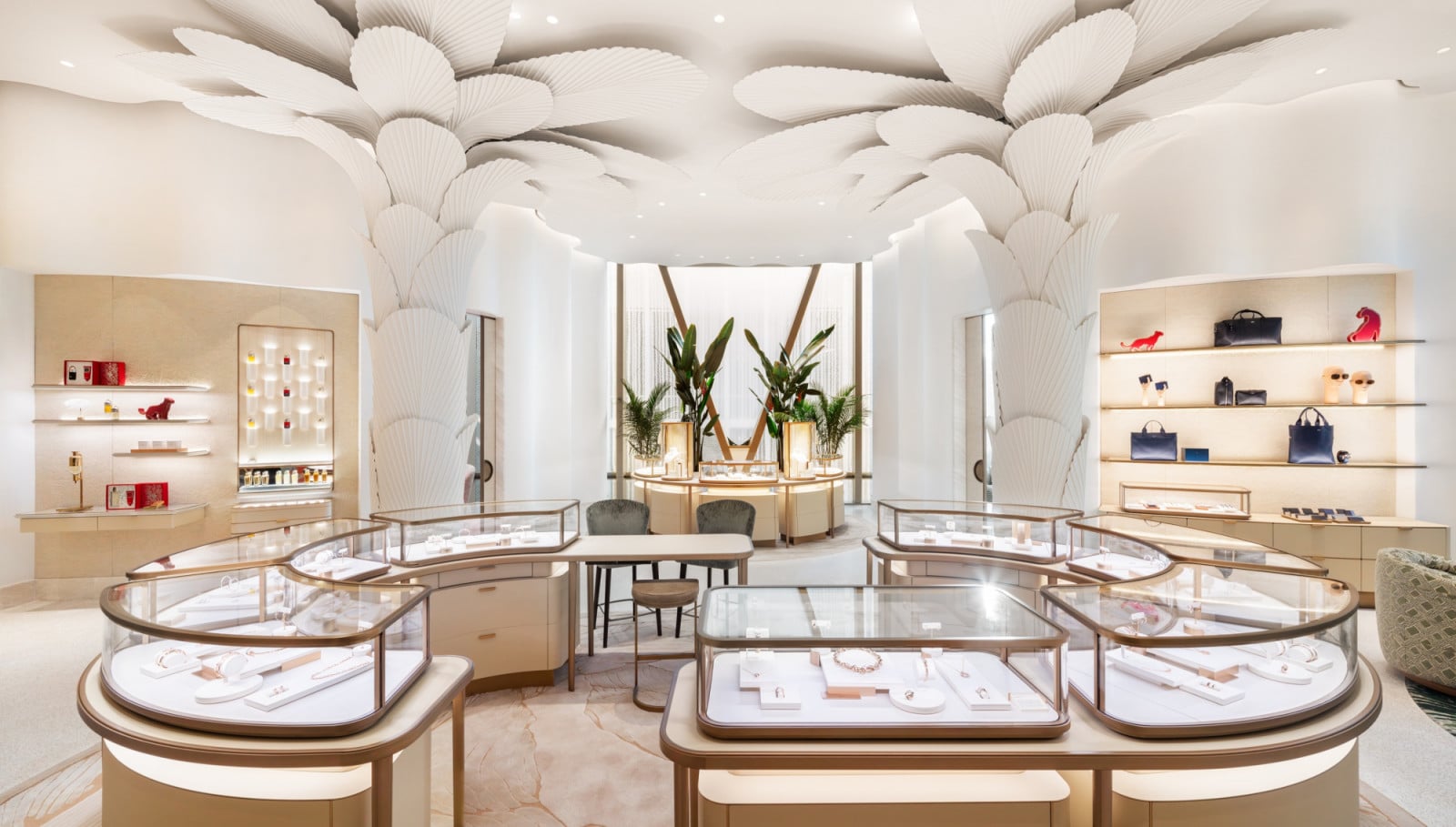 Sculptural white panels, folded to resemble palm fronds, spread across the ceiling above a central run of glass display cases