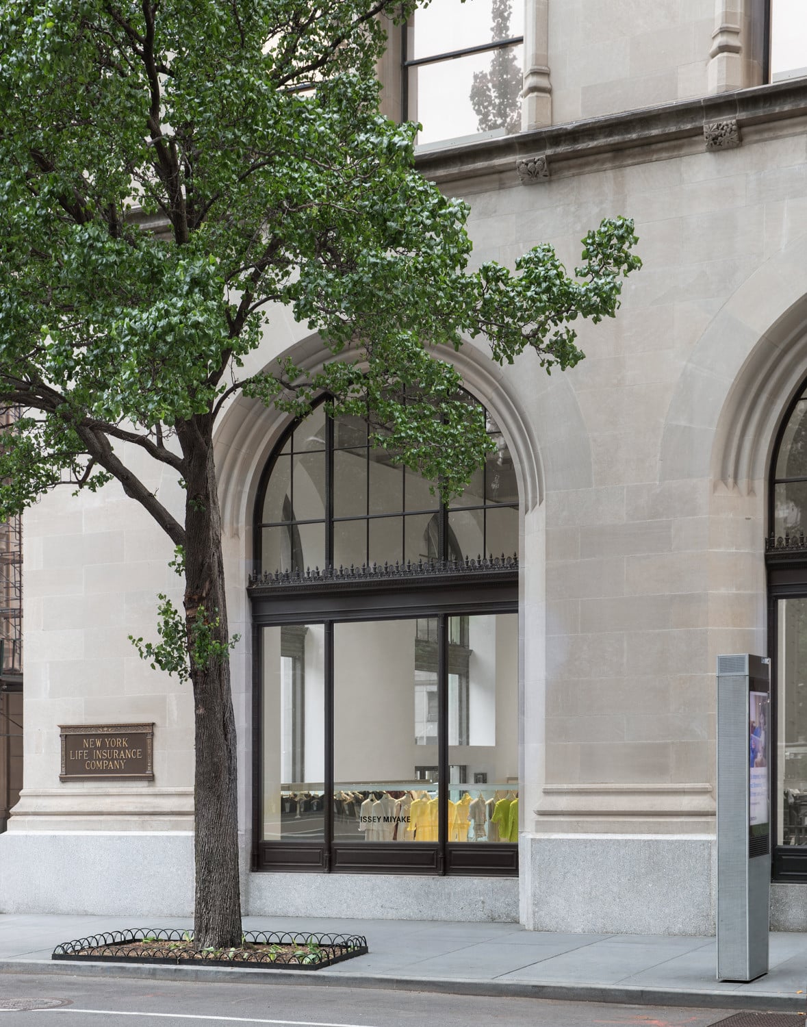 A bronze plaque marking the building as the former New York Life Insurance Company is fixed to the stone beside the entrance (Photo: Naho Kubota)