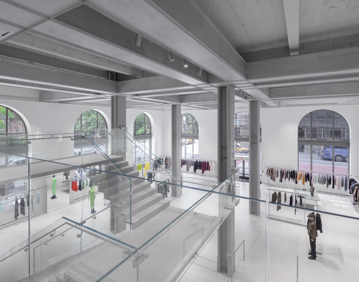 The store’s structural steel columns and riveted beams are left exposed above a glass staircase connecting two levels (Photo: Naho Kubota)