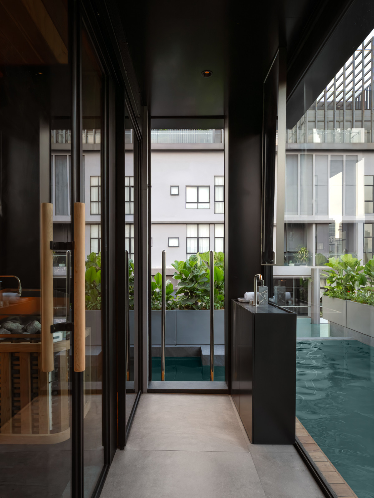 The compact rooftop bathroom tucked between the gym and the jacuzz