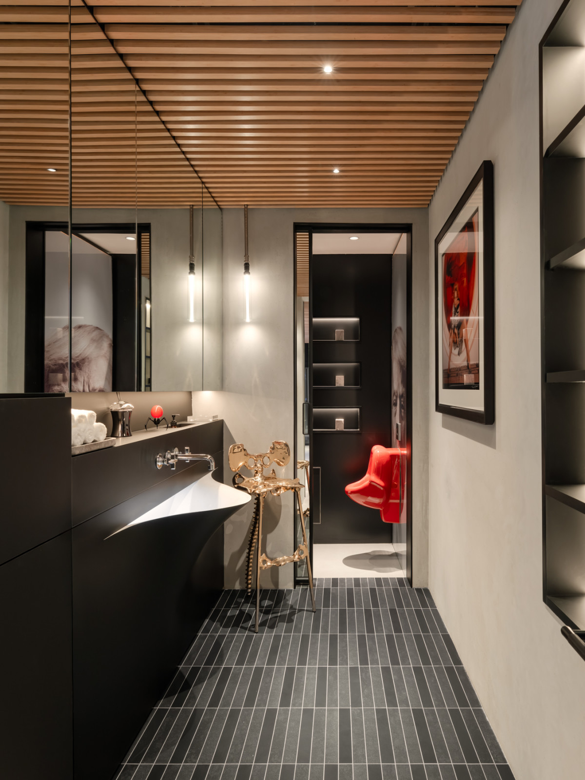 The powder room, with the asymmetric Antonio Lupi basin set into a matte black vanity