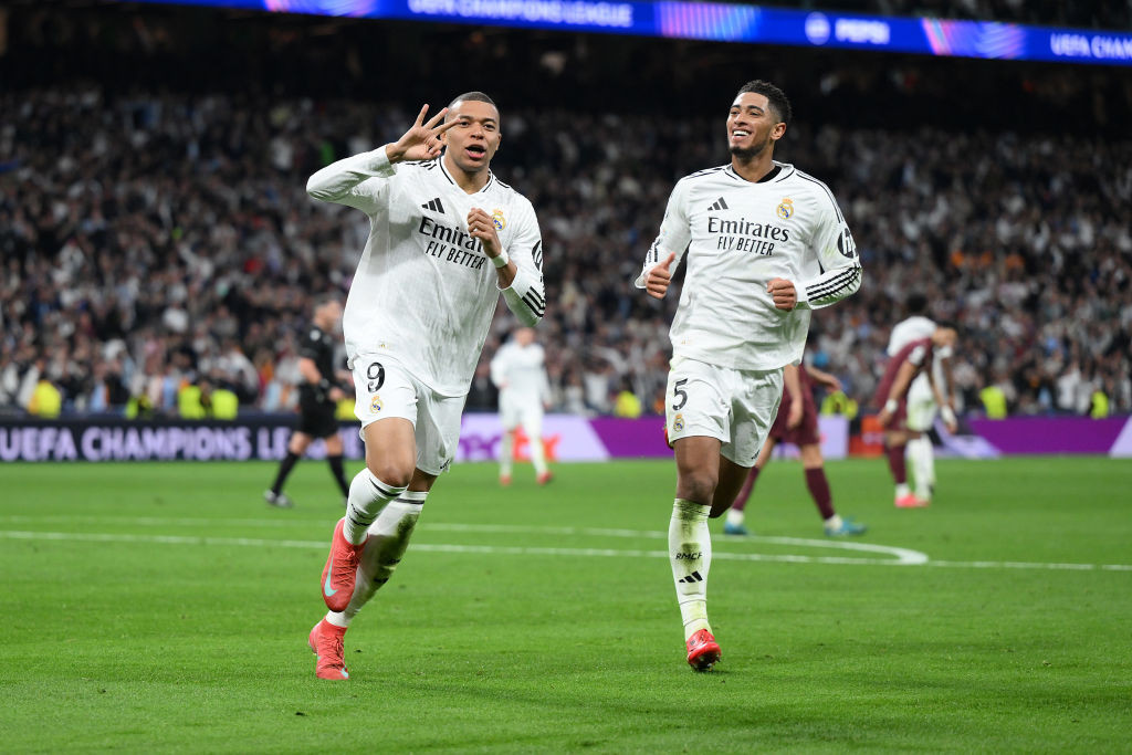 MADRID, SPAIN - FEBRUARY 19: Kylian Mbappe of Real Madrid celebrates scoring his team's third goal and his hat trick with teammate Jude Bellingham during the UEFA Champions League 2024/25 League Knockout Play-off second leg match between Real Madrid C.F. and Manchester City at Santiago Bernabeu Stadium on February 19, 2025 in Madrid, Spain. (Photo by David Ramos/Getty Images)