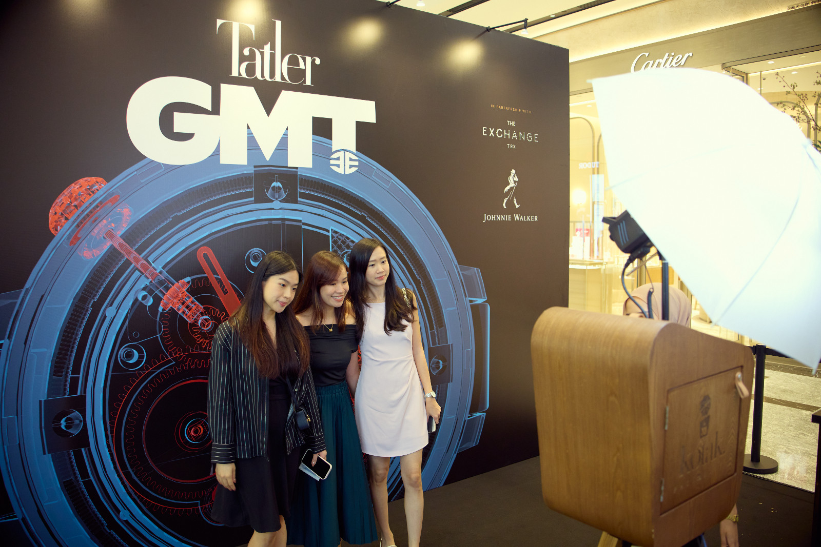 Guests taking instant pictures at Kotak photobooth
