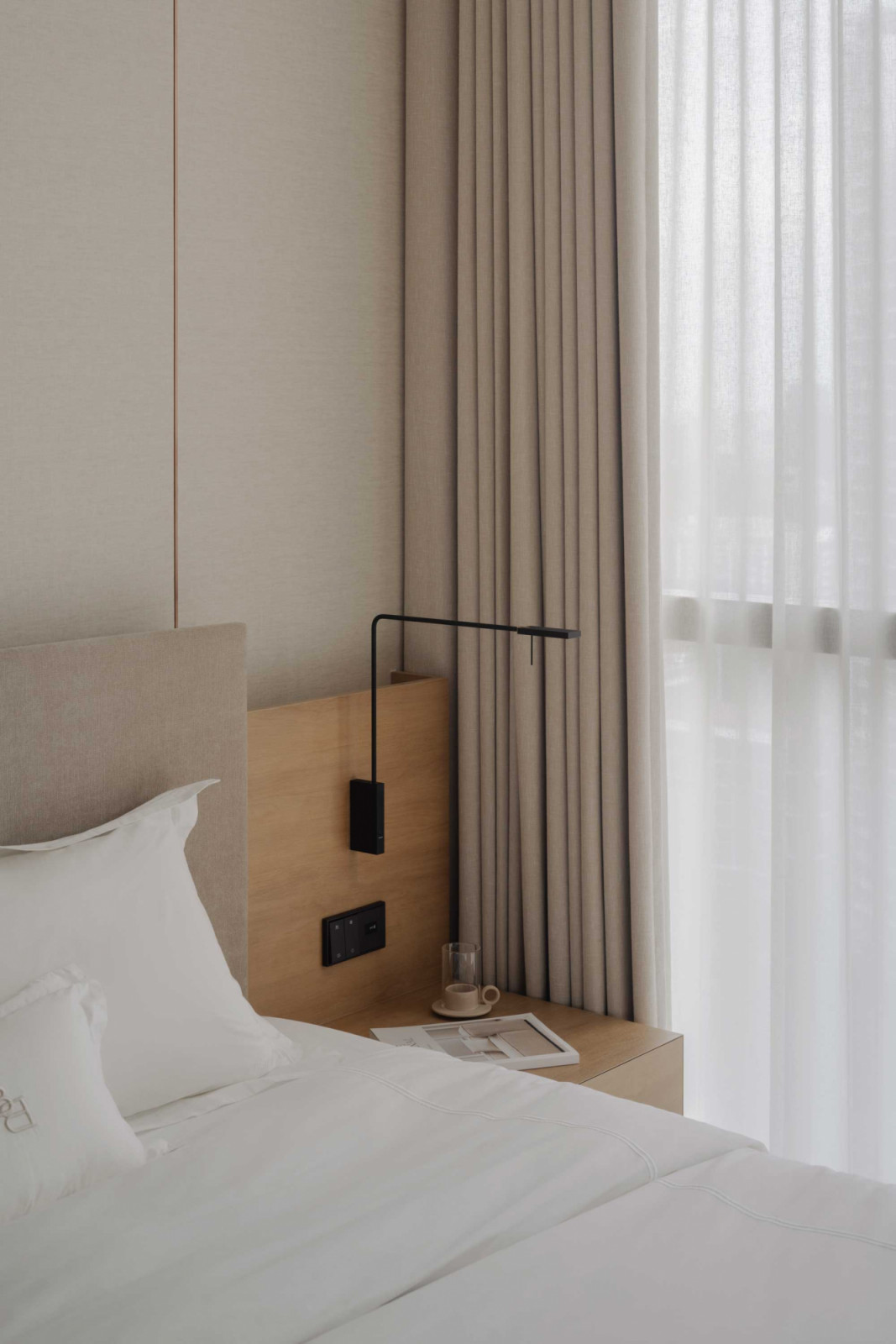 The bedroom is composed with a sense of repose