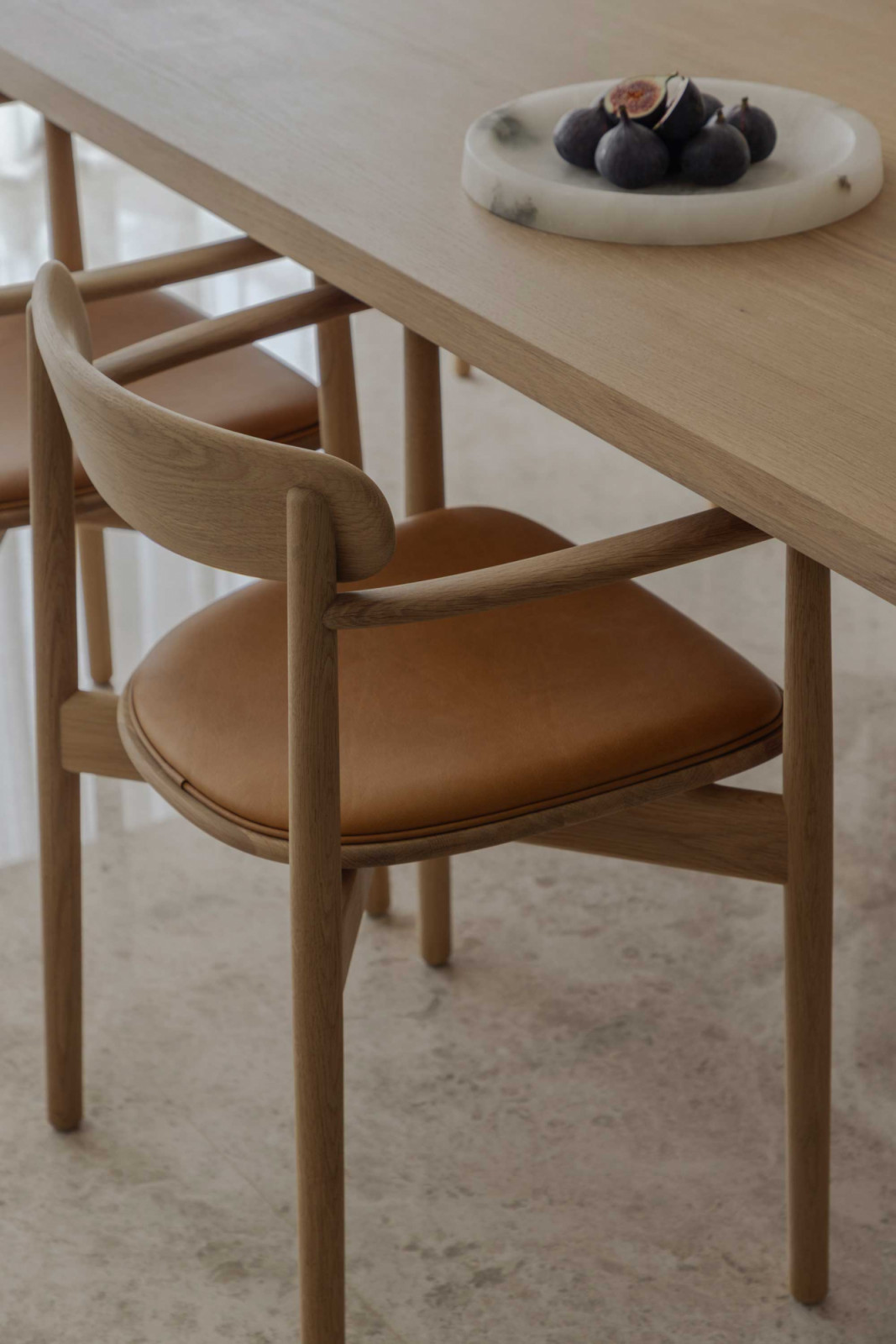 The curves of the dining chairs invite a gentle embrace