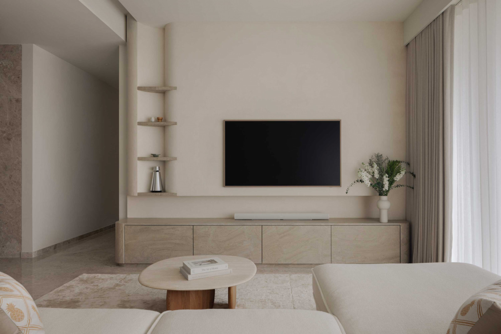 Sheer curtains and gentle curves soften the living space