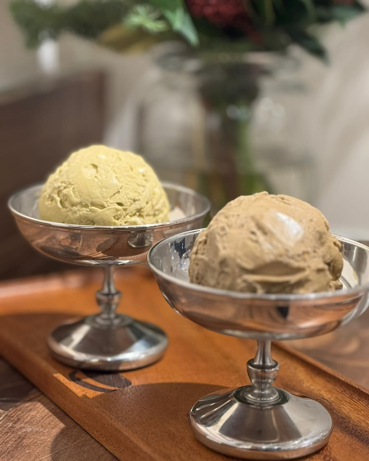 Pistachio and coffee ice cream scoops are served in elegant silver coupes at Ice Cream & Cookie Co.