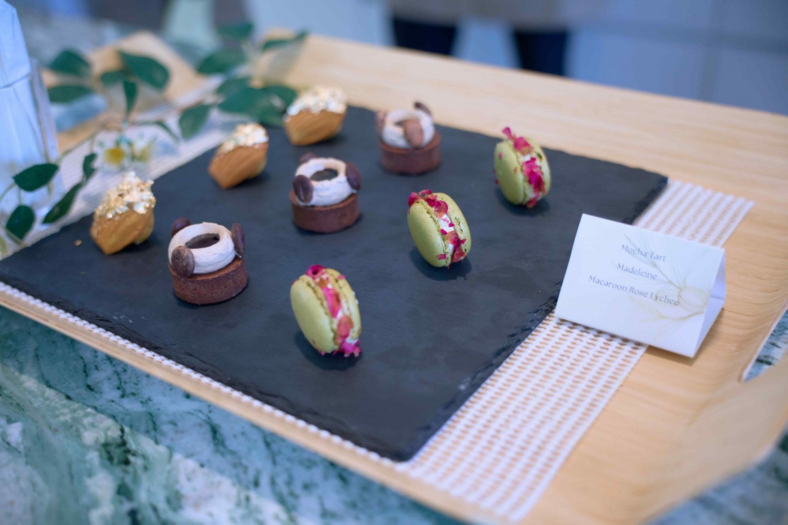 Sweet canapés include madeleines, mocha tarts, and rose lychee French macarons