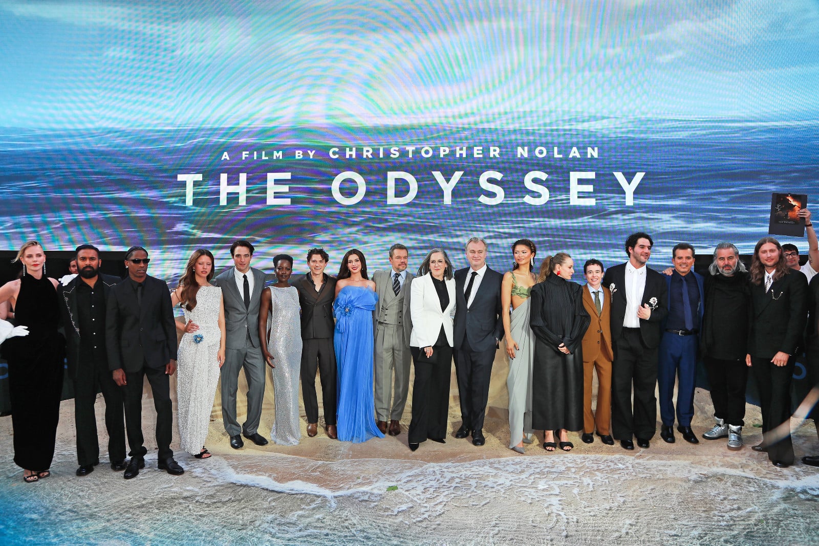Discover how Christopher Nolan is deploying a massive, star-studded ensemble to turn an ancient story of survival, isolation and domestic warfare into a modern psychological thriller. In photo, ‘The Odyssey’ cast: Charlize Theron, Himesh Patel, Travis Scott, Mia Goth, Robert Pattinson, Lupita Nyong'o, Tom Holland, Anne Hathaway, Matt Damon, Chairperson of Universal Pictures Donna Langley, Emma Thomas, Christopher Nolan, Brian L. Roberts, Zendaya, Samantha Morton, Elliot Page, Benny Safdie, guest, John Legui