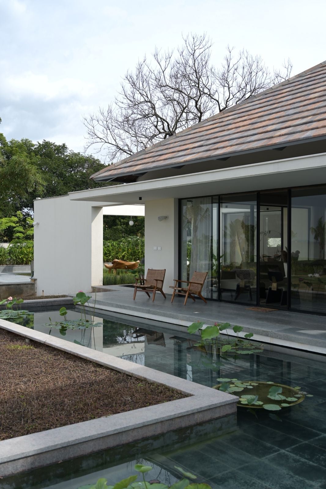An elevated plinth creates the illusion of the house hovering lightly above the ground