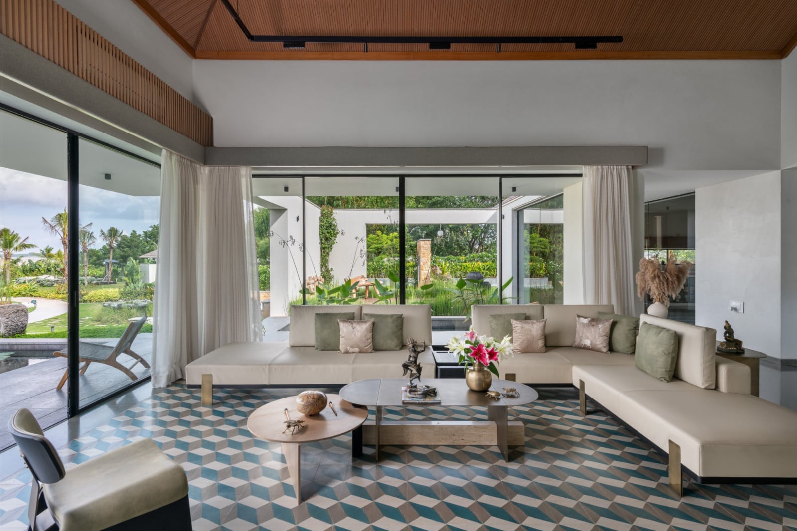 In the main living hall, geometric flooring inspired by the traditional Athangudi tile-making process introduces measured pops of colour using natural dyes