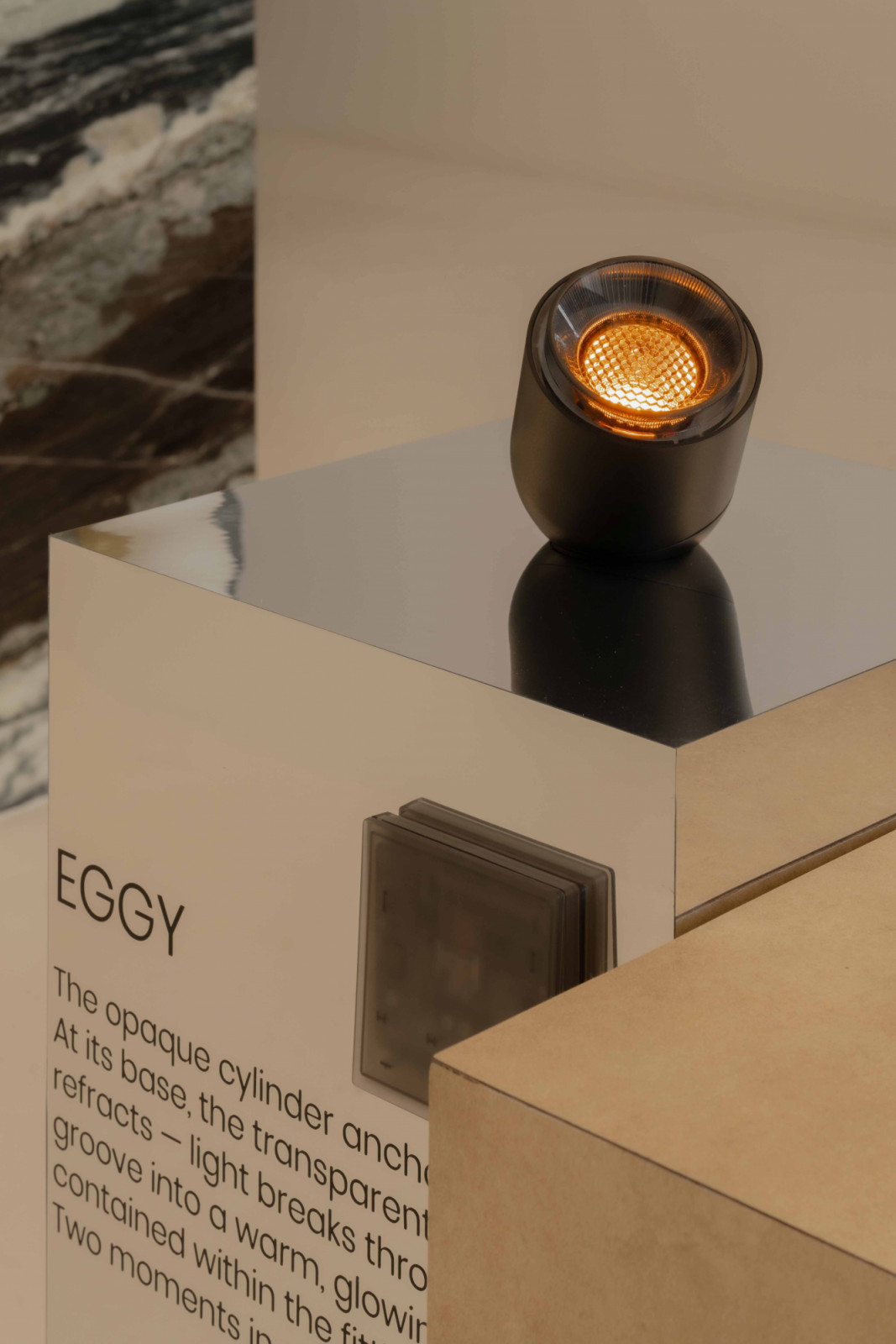 The Aeon Eggy, whose transparent fluted funnel refracts light into a warm, glowing ring