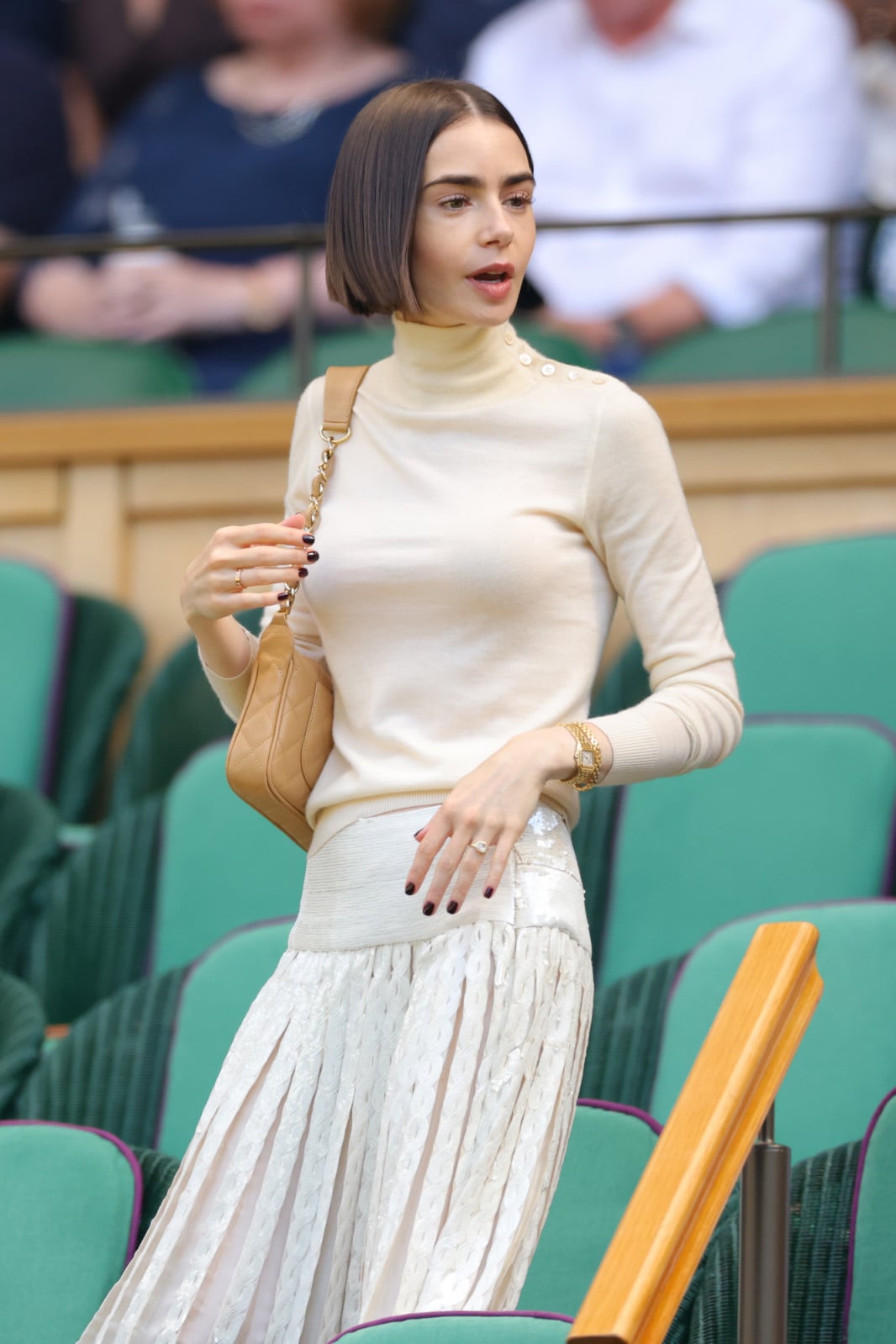 LONDON, ENGLAND - JULY 11: Lily Collins, wearing Ralph Lauren on day thirteen of The Championships Wimbledon 2026 at All England Lawn Tennis and Croquet Club on July 11, 2026 in London, England. (Photo by Shaun Brooks - CameraSport via Getty Images)