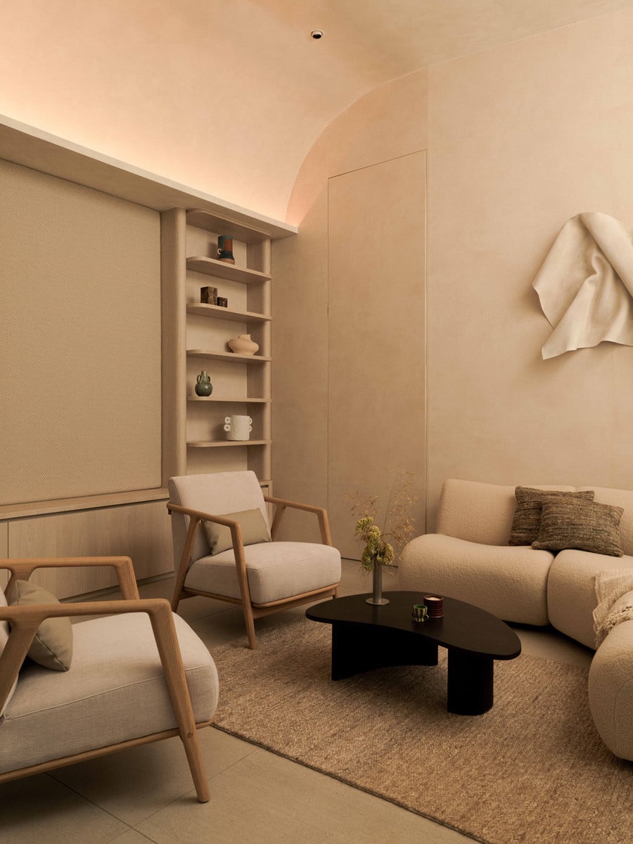 A curved, barrel-vaulted ceiling and built-in shelving lend an intimate, gallery-like quality to the studio