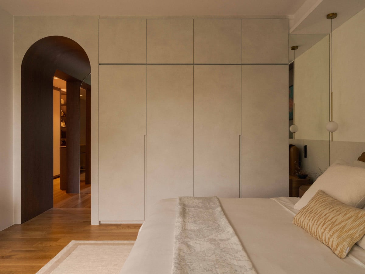 Flush cabinetry and a restrained palette reinforce the master bedroom’s intent as a pared-back sanctuary