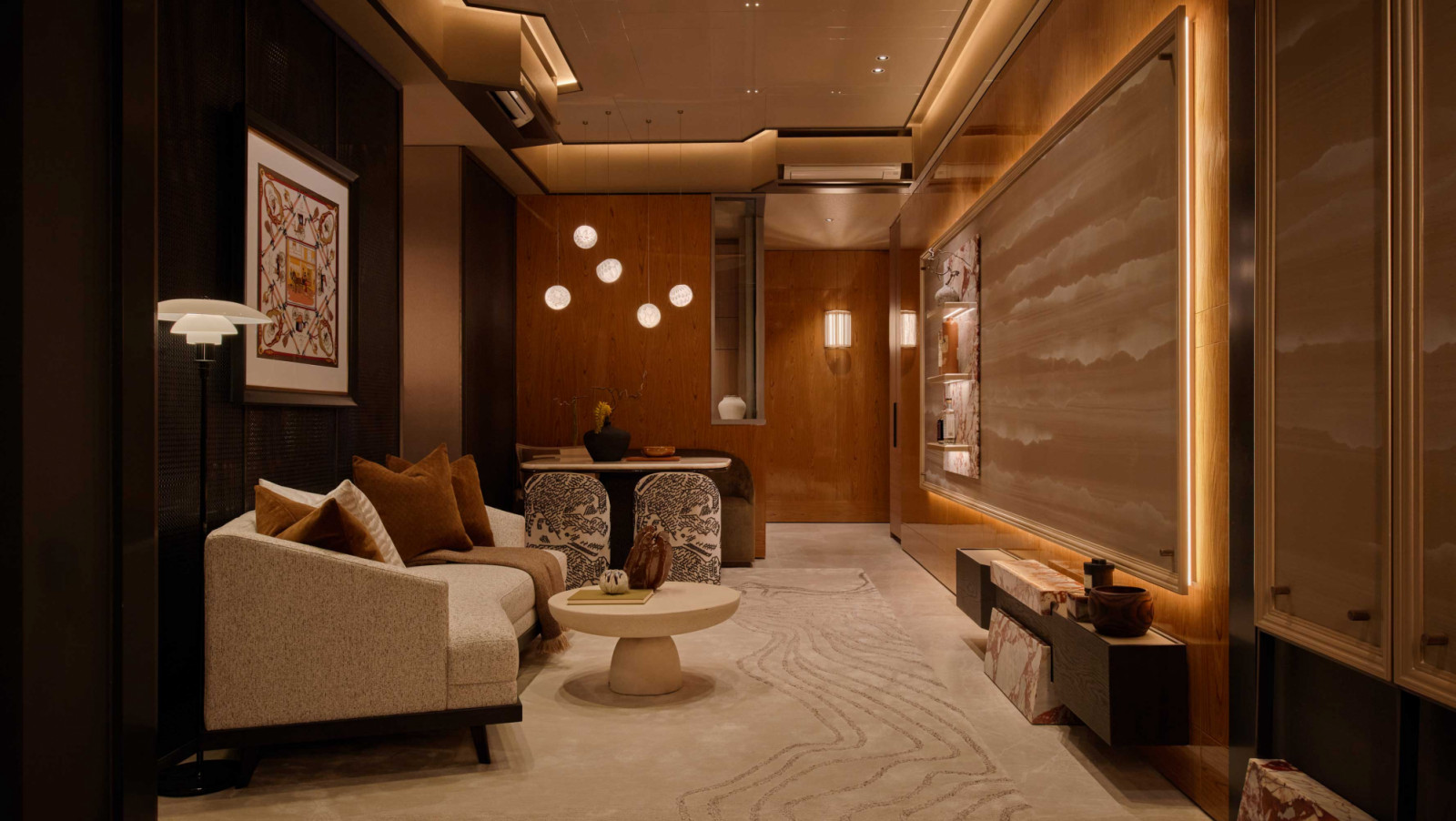 This amber-lit living and dining space, designed by Sujonohun, sets a warm first impression