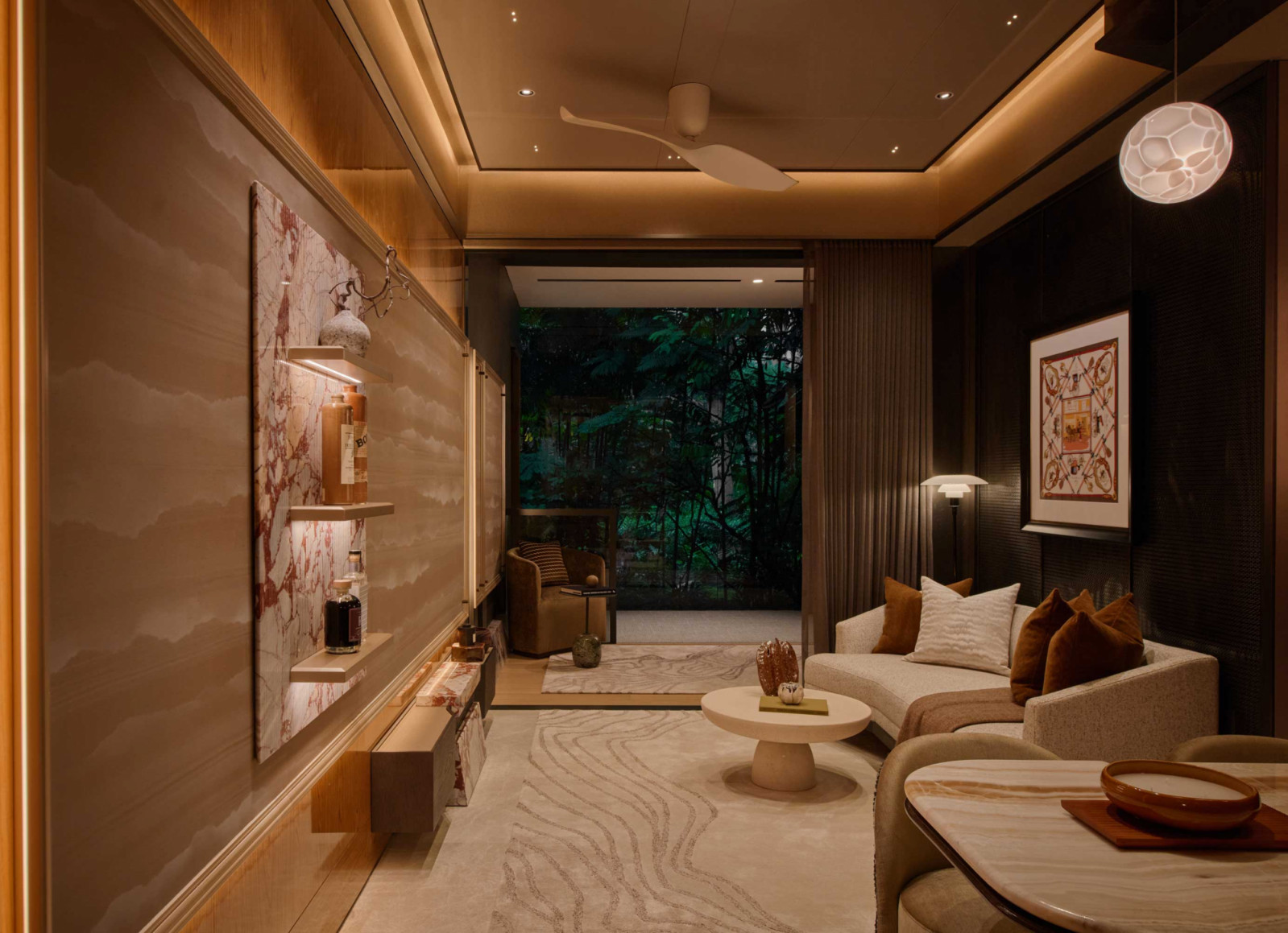The living area extends towards the balcony, where a restrained material palette creates continuity between the indoors and out