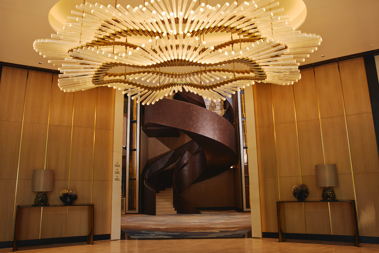 The staircase by Rita Nazareno and Gabby Lichauco with a Lasvit chandelier at Aurelia Residences in Bonifacio Global City, Manila