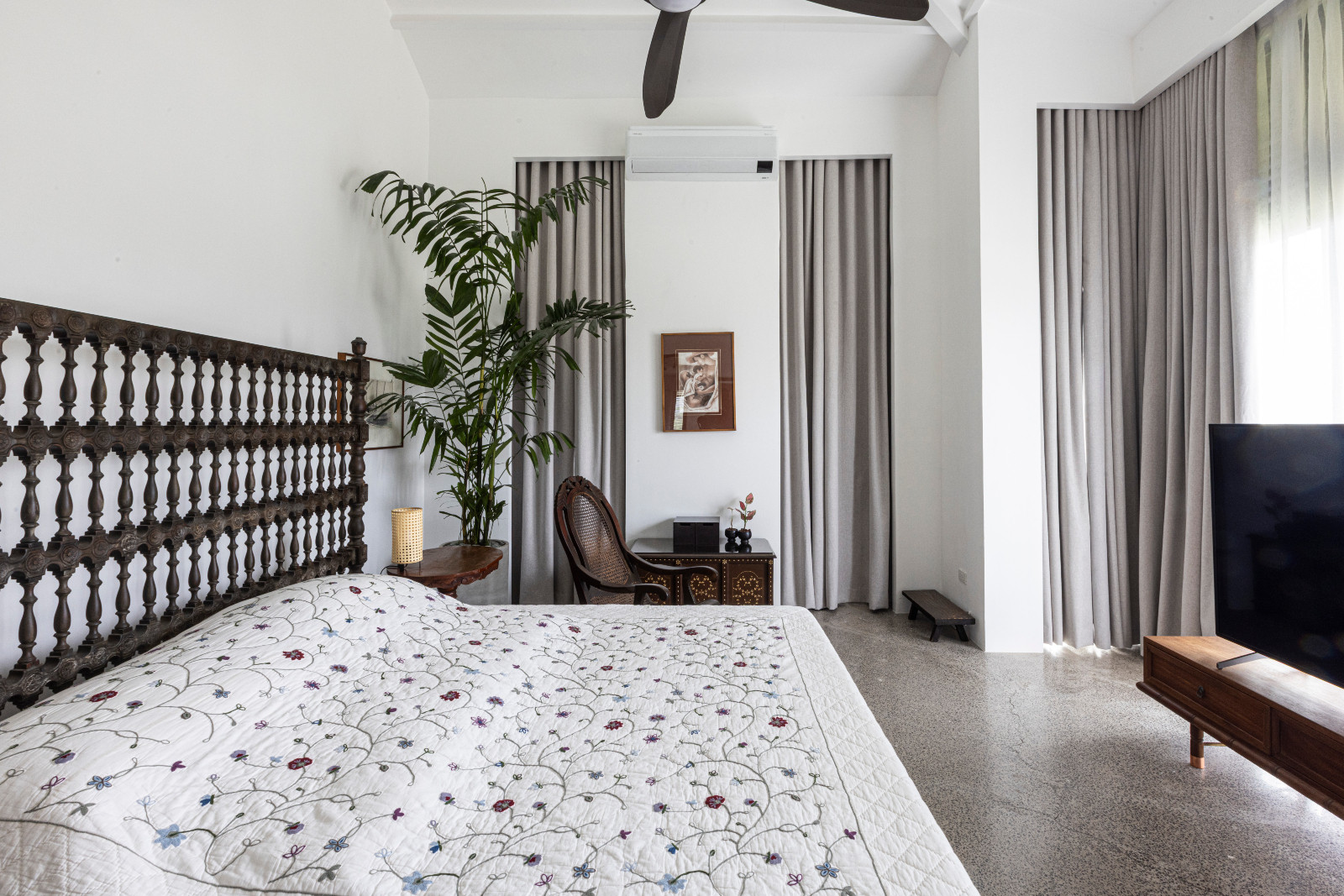 The bedroom of a black-and-white heritage home designed by architect Miko De Los Reyes of Imagimax in Manila, Philippines