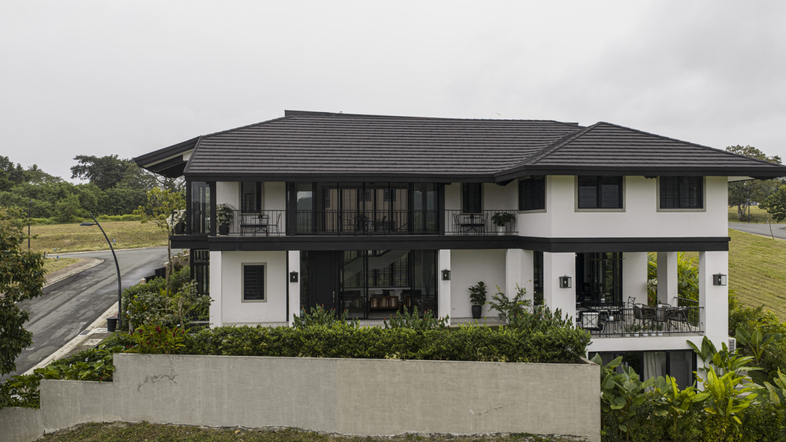 The exterior of a black and white heritage home designed by architect Miko De Los Reyes of Imagimax in Manila, Philippines