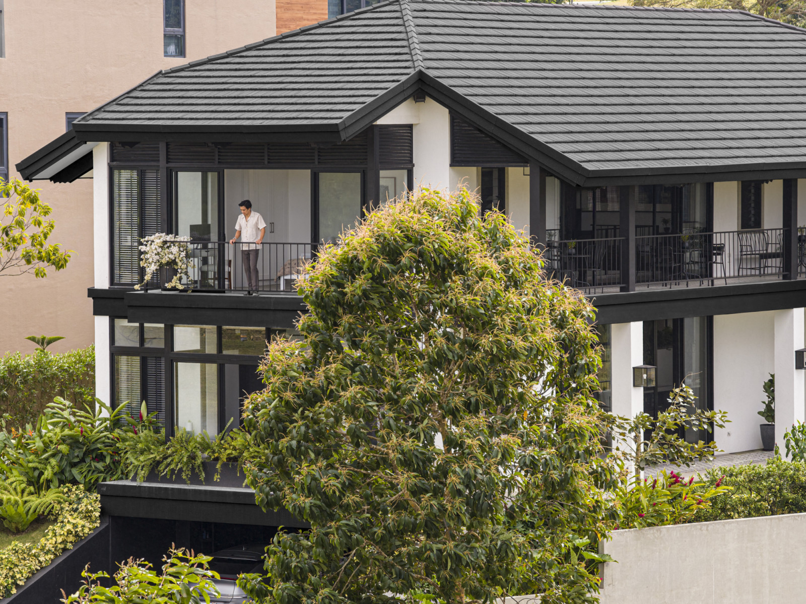The exterior of a black-and-white heritage home designed by architect Miko De Los Reyes of Imagimax in Manila, Philippines