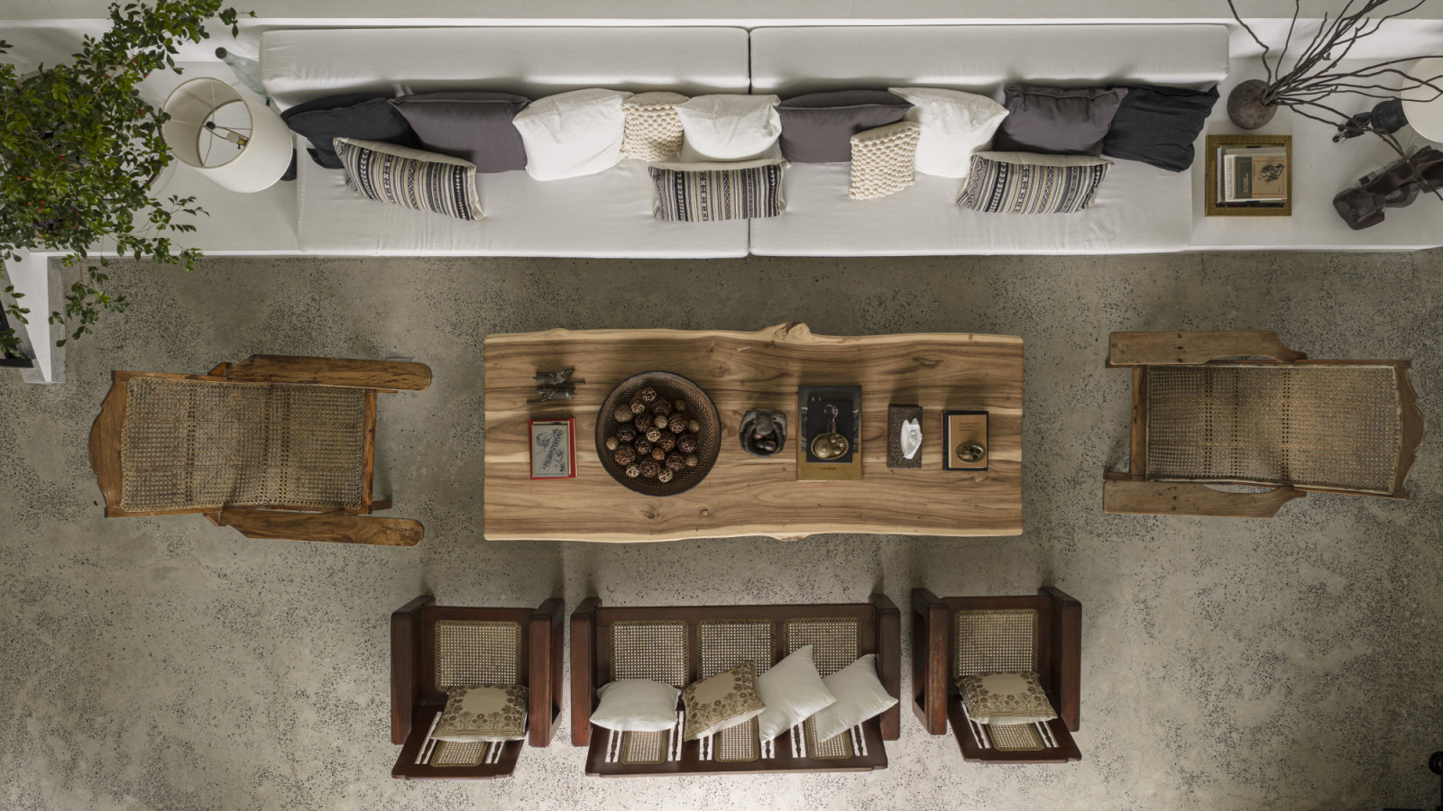 An aerial view of the living room in a black-and-white heritage home designed by architect Miko De Los Reyes of Imagimax in Manila, Philippines