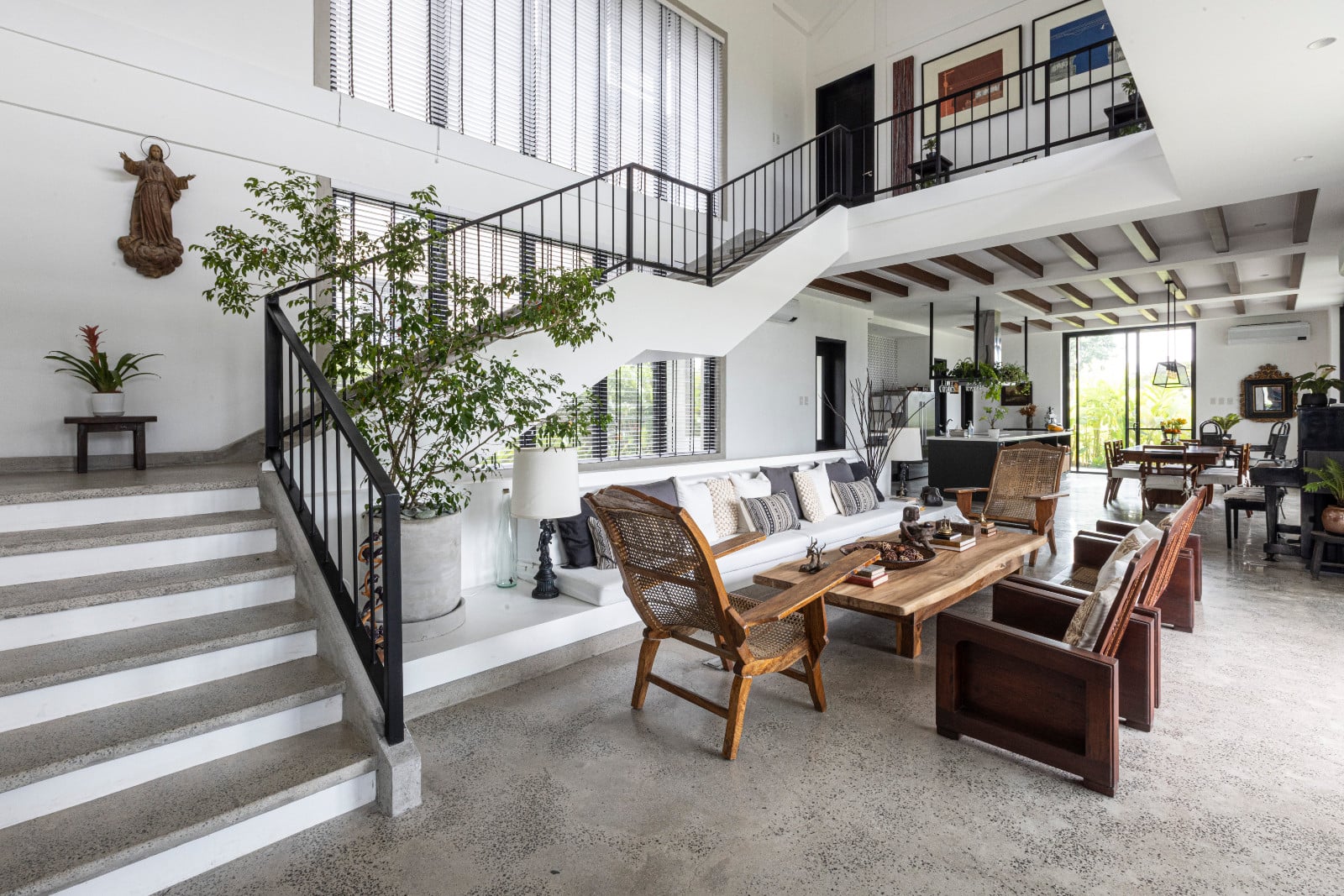 The open floor plan of a black-and-white heritage home designed by architect Miko De Los Reyes of Imagimax in Manila, Philippines