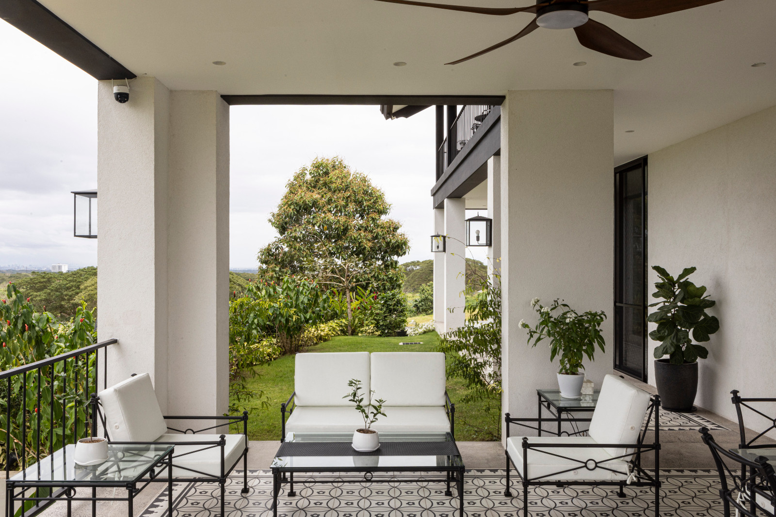 The outdoor lanai of a black-and-white heritage home designed by architect Miko De Los Reyes of Imagimax in Manila, Philippines