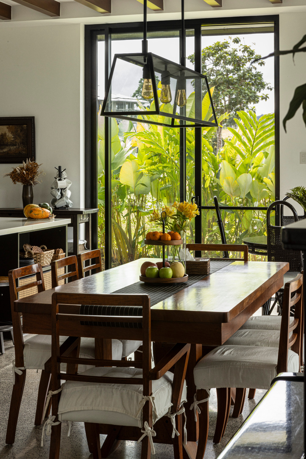 The breakfast nook of a black-and-white heritage home designed by architect Miko De Los Reyes of Imagimax in Manila, Philippines