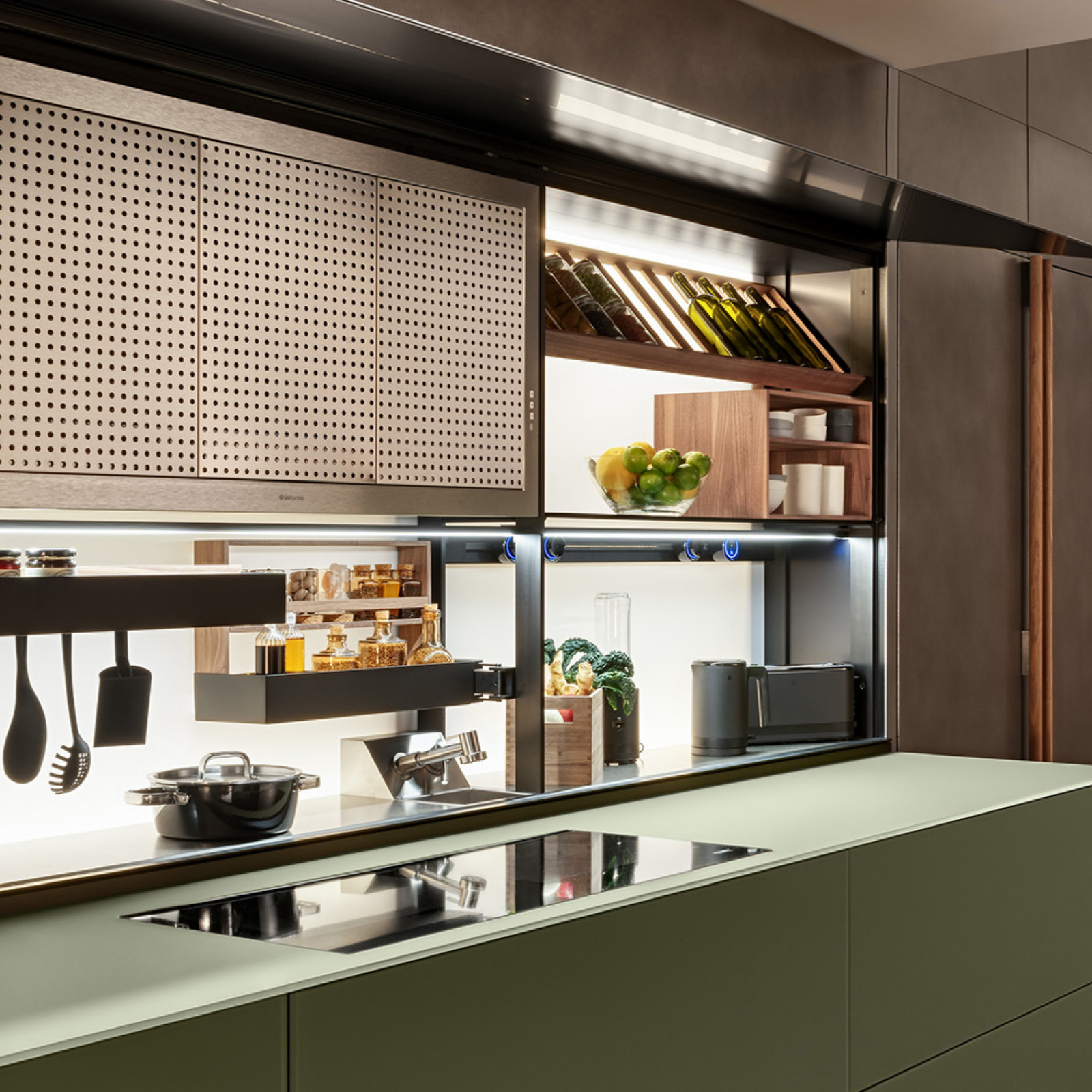 The Logica Celata system by Valcucine reveals integrated culinary workspaces, bars or hidden pantries behind a counterweighted glass front