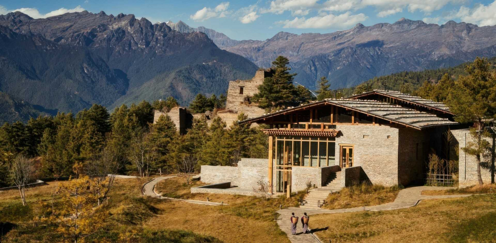 Six Senses Paro’s stone-and-timber lodge sits beneath the ruins of an old watchtower, framed by the Himalayan foothills