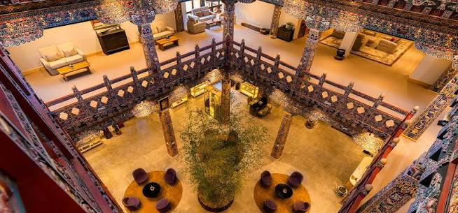 An aerial view inside Zhiwaling Heritage’s lobby shows the hand-carved and hand-painted timber gallery encircling a central atrium garden