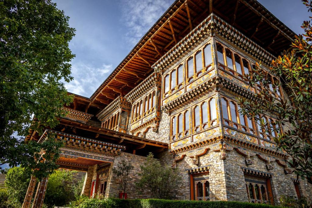 Hand-painted murals and carved timber balconies wrap Zhiwaling Heritage’s stone facade, built without a single nail