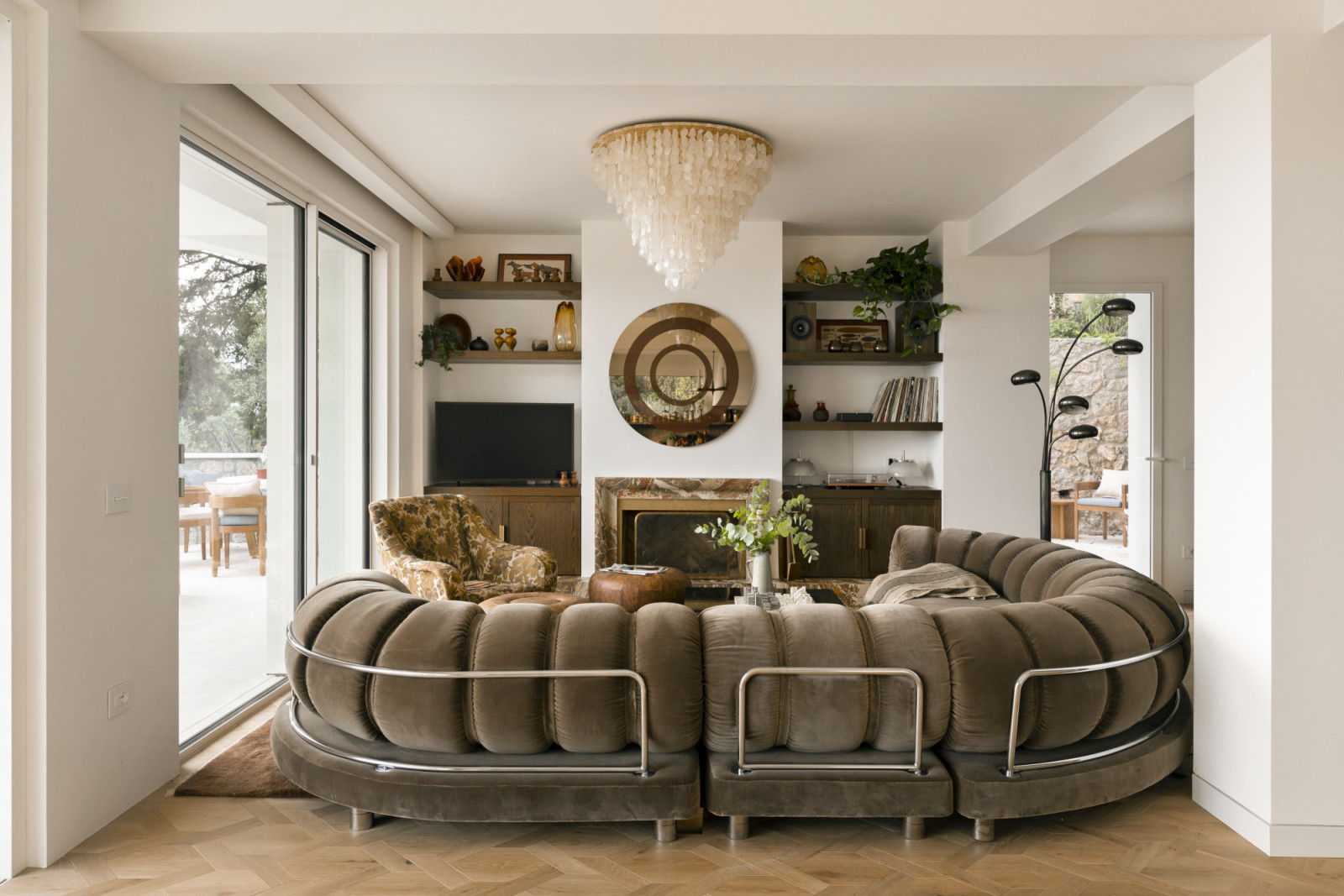 The living room with larger openings to bring in views of the sea and the sunset, featuring a 1970s Morentz sofa reupholstered in De Le Cuona mohair