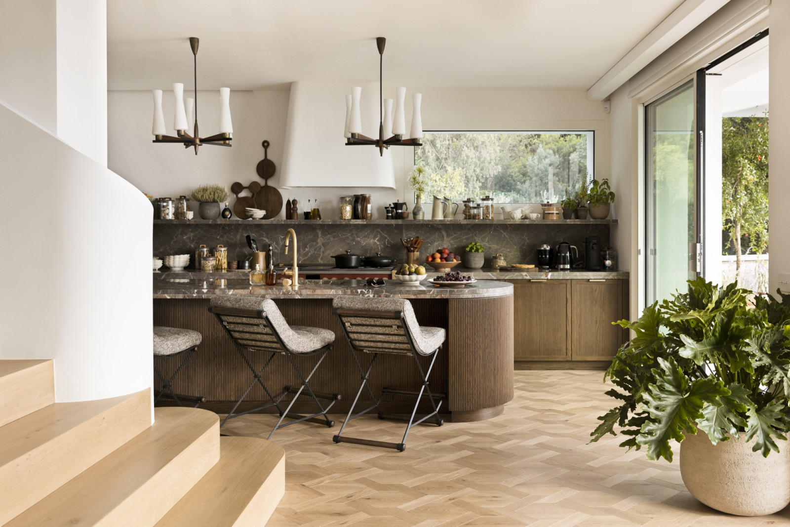 The kitchen area that opens onto the expansive outdoor spaces