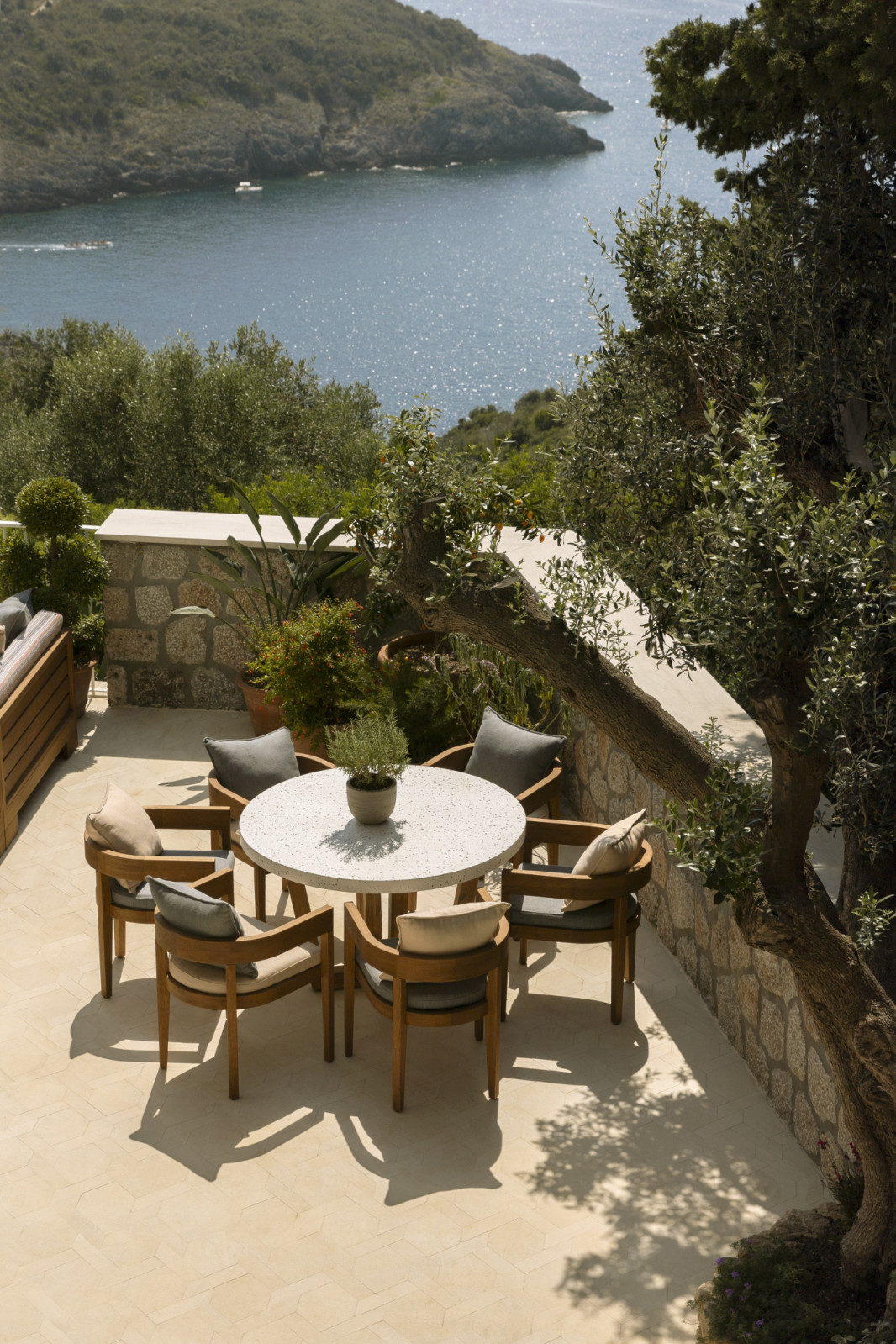 The outdoor dining table overlooks the sea