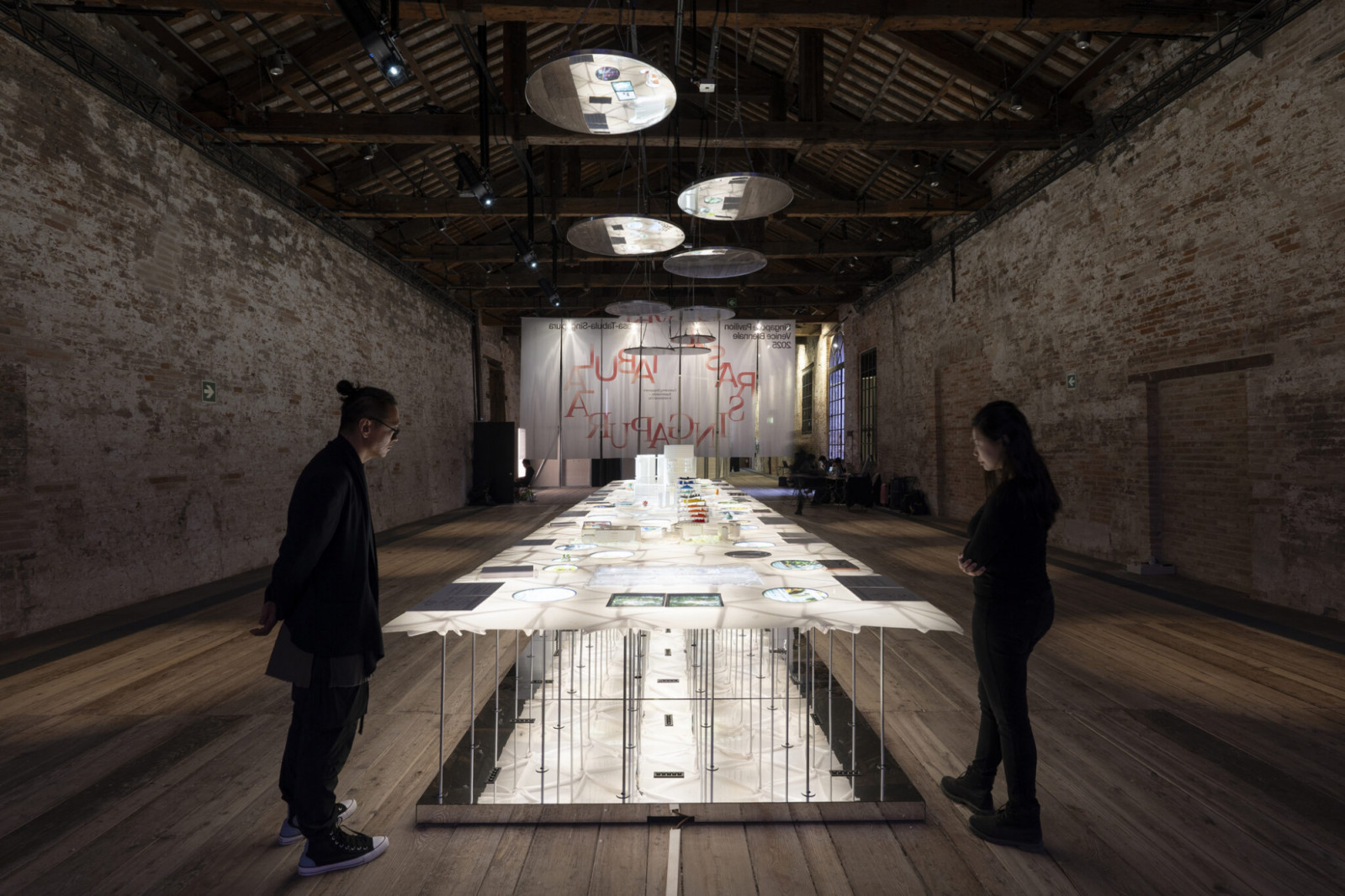 The table is a 12m-long resin-reinforced cloth created by a team led by Jason Lim of Yume Architects, who drew upon the experimental work of Frei Otto and Heinz Isler