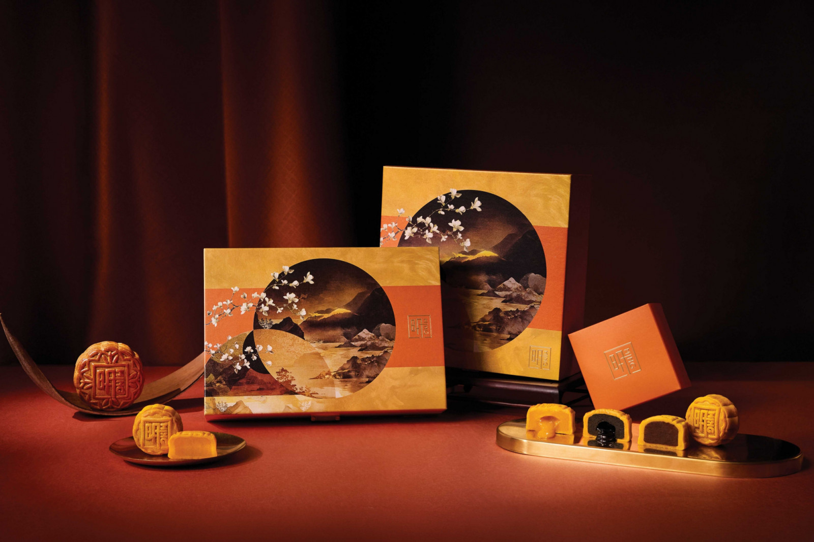 Ming Court mooncakes featuring varied fillings are presented in artfully designed gift boxes.