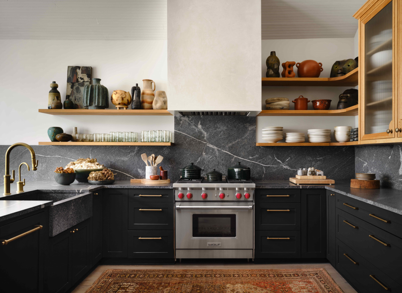 The remodelled kitchen featuring brass tapware and distinctive natural stone