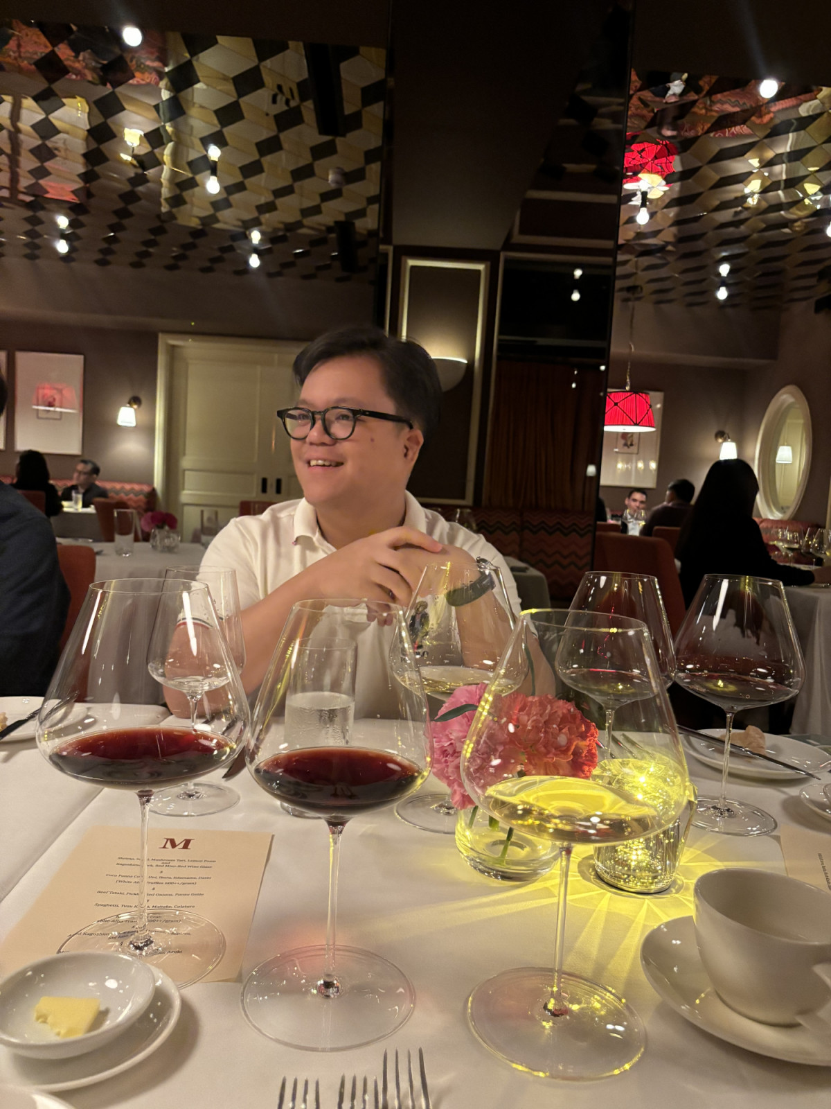 Roman Recto enjoying a memorable meal with notable glasses of red wine, at M Dining