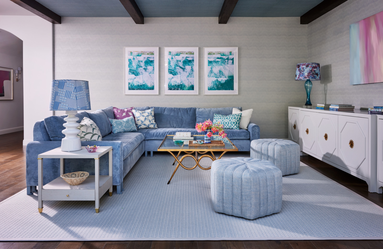 Soft shades of blue echo hues of the artworks on the wall