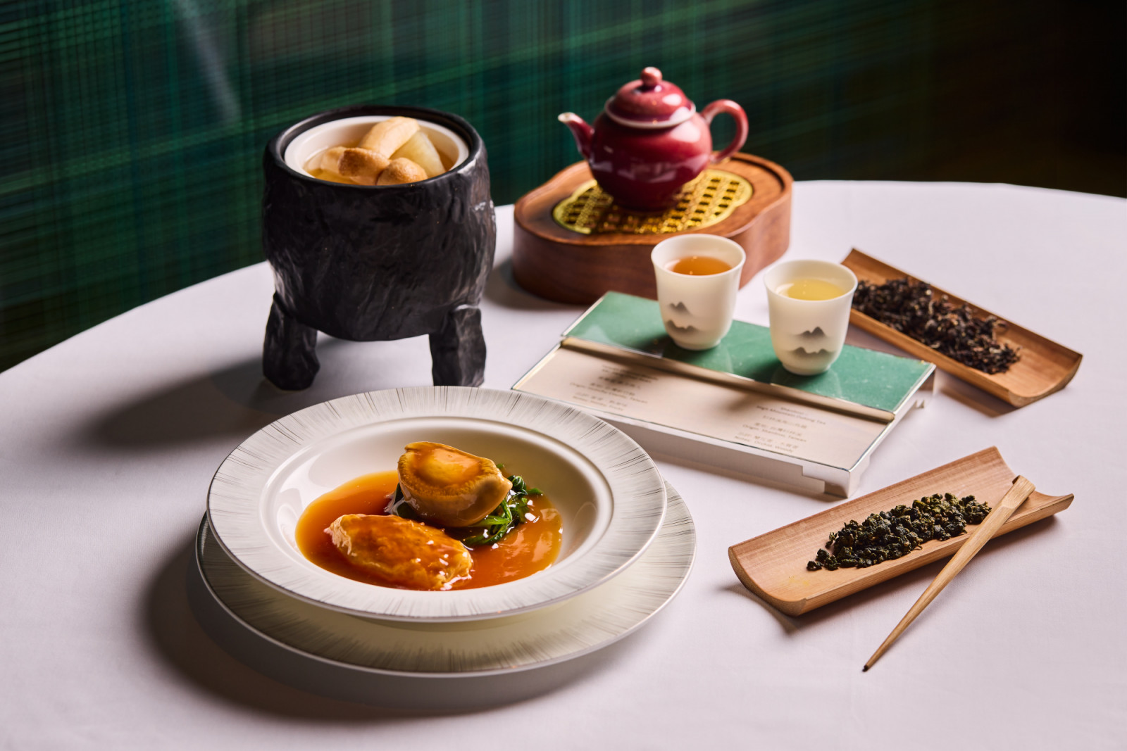 Braised abalone, deep-fried buns, and a fine tea selection featuring High Mountain Oolong at Lai Ching Heen.