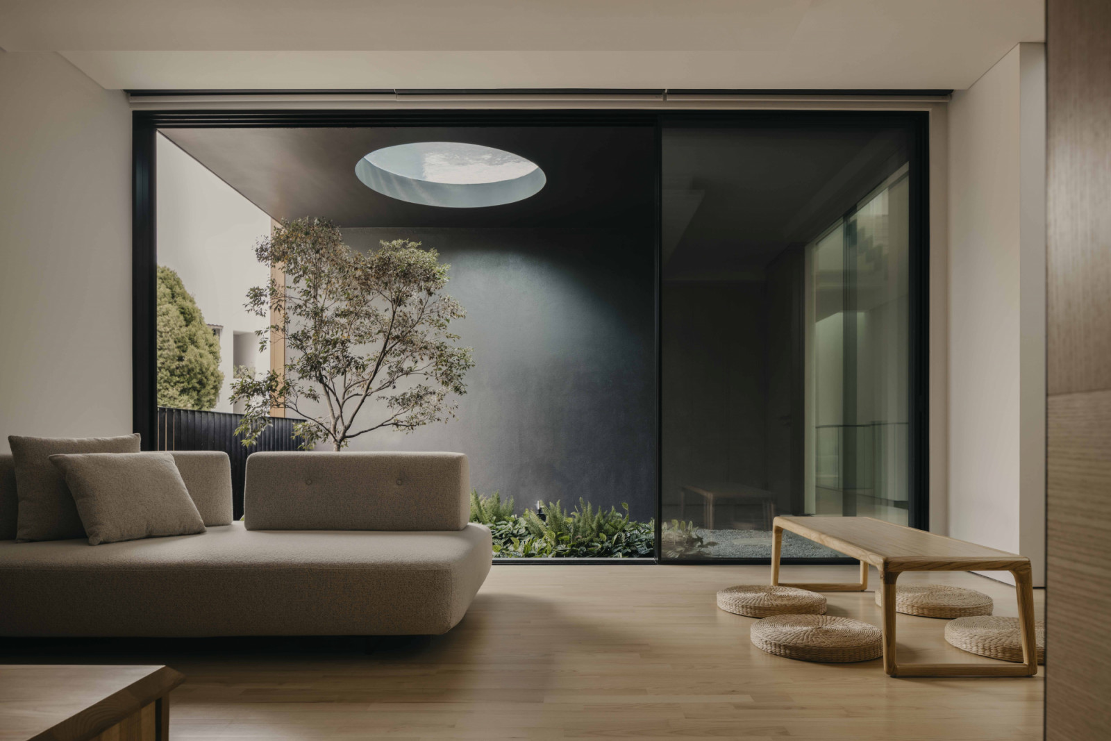 A series of courtyards and skylights are inserted along the length of the house, drawing natural light deep into the interior and facilitating cross-ventilation throughout