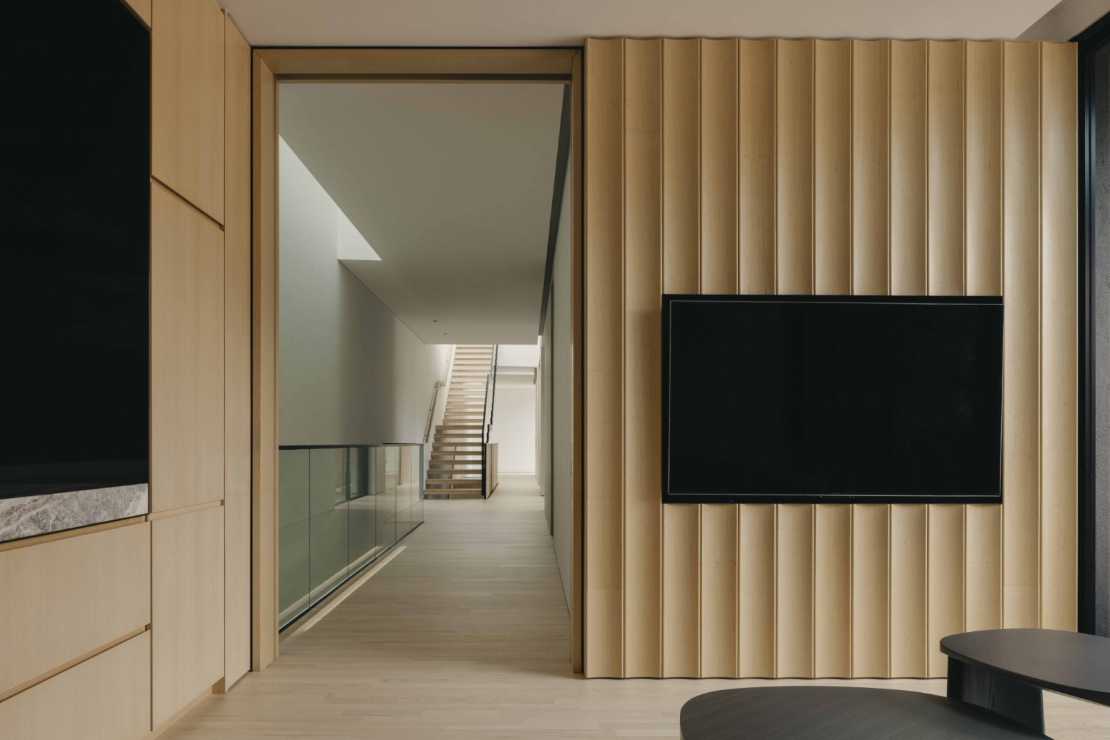 Wave-like sculptural forms add an unexpected touch to this television wall